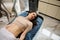 Caucasian pretty woman with naked belly lies on a couch in spa clinic before ultrasonic cavitation therapy, anti-cellulite