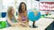 Caucasian primary school girl and her teacher looking at a globe