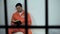 Caucasian prisoner reading bible in cell, convicted sinner turning to religion