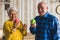 Caucasian retired grandmother and grandfather in an old fashioned apartment holding fresh red and green apples. Healthy
