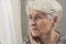 caucasian sad lonely pensive elderly woman with short grey hair and wrinkled face