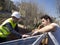 Caucasian seasoned technician showing the solar panels to his young client