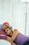 Caucasian senior woman with breast cancer patient lying on hospital bed with daughter supporting