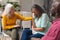 Caucasian senior woman consoling crying female during group therapy session