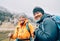 Caucasian and Sherpa men with backpacks together smiling at camera Makalu Barun Park trekking route. Mera peak climbing