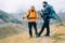 Caucasian and Sherpa men with backpacks with trekking poles together smiling enjoying Mera peak climbing acclimatization walk