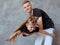 Caucasian siblings - teenager boy brother and little girl sister playing in aircraft in modern loft