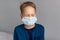 Caucasian sick boy wearing a protective mask. Contagious virus concept. Coronovirus concept.