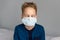Caucasian sick boy wearing a protective mask. Contagious virus concept. Coronovirus concept.