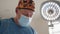 Caucasian surgeon male healthcare professional in a hospital operating theatre wearing a surgical cap and mask. Portrait