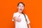 A caucasian surprised little long haired one braid girl in blank white t-shirt showing thumbs up