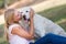 Caucasian teenager girl with old senior labrador dog in the park