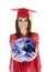 Caucasian teenager wearing a graduation gown holding the earth