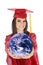 Caucasian teenager wearing a graduation gown holding the earth