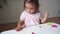 Caucasian toddler girl playing modeling play dough at home with mother. Homeschooling concept