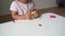 Caucasian toddler girl playing modeling play dough at home with mother. Homeschooling concept
