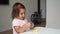 Caucasian toddler girl playing modeling play dough at home with mother. Homeschooling concept