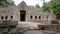 caucasian tourist drinking water in preah khan temple, angkor, cambodia