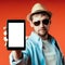 A Caucasian tourist in a hat and sunglasses shows information or a mobile application for travelers on a tablet.