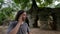 caucasian tourist talking with mobile phone, ruins in tropical jungle