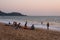 Caucasian Tourists and families relaxing and enjoying on the beach at Agonda Beach in Goa, India