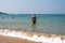 Caucasian Tourists and families relaxing and enjoying on the beach at Agonda Beach in Goa, India