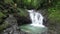 Caucasian tourists swimming in the tropical waterfall in Costa Rica.