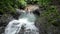 Caucasian tourists swimming in the tropical waterfall in Costa Rica.