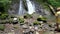 Caucasian tourists swimming in the tropical waterfall in Costa Rica.