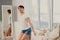 Caucasian transgender man posing in shorts in the bedroom. Openly gay.