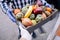 Caucasian volunteer man gives the box from grocery store to a woman at her home