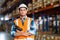 Caucasian warehouse worker standing in a large warehouse distribution center