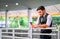 Caucasian white business man look at his mobile phone and stand at sky train walk way, also expressed sad emotion during day time