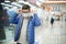 Caucasian white teenager putting on face mask in shopping mall