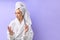Caucasian woman in bathrobe trims nails