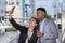 caucasian woman and black man communicate online with friend via mobile. businessman and businesswoman live social outside