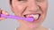 Caucasian woman brushes her teeth with a toothbrush with paste. Daily oral hygiene