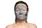 Caucasian woman with a clay or a mud mask on her face over white background. Solving acne problems, cleansing, smoothing