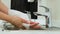 Caucasian woman cleaning her hands with white soft tissue paper in the clinic