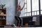 Caucasian woman doing Utkatasana, Chair Pose using block at home