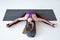 Caucasian woman doing youga splits upavistha konasana on fitness mat