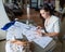 Caucasian woman draws watercolor sketches of sportswear. Close-up of the hands of a fashion designer.