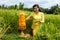 Caucasian woman dressed in traditional Balinese costume praying using god\'s offerings. Hindu religious ceremony. Culture and