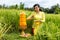 Caucasian woman dressed in traditional Balinese costume praying using god\'s offerings. Hindu religious ceremony. Culture and