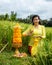 Caucasian woman dressed in traditional Balinese costume praying using god\'s offerings. Hindu religious ceremony. Culture and