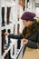 Caucasian woman dressed in warm clothing shopping for shoes