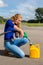 Caucasian woman fueling jerrycan with petrol