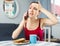 Caucasian woman having fever sitting and talking on phone