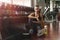 Caucasian woman having relax after workout and excercise in gym and fitness club with roll of dumbells on rack, healthy sports