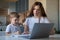 Caucasian woman helps boy learn lessons. The tutor checks the child`s homework. Individual home-based quarantine. A